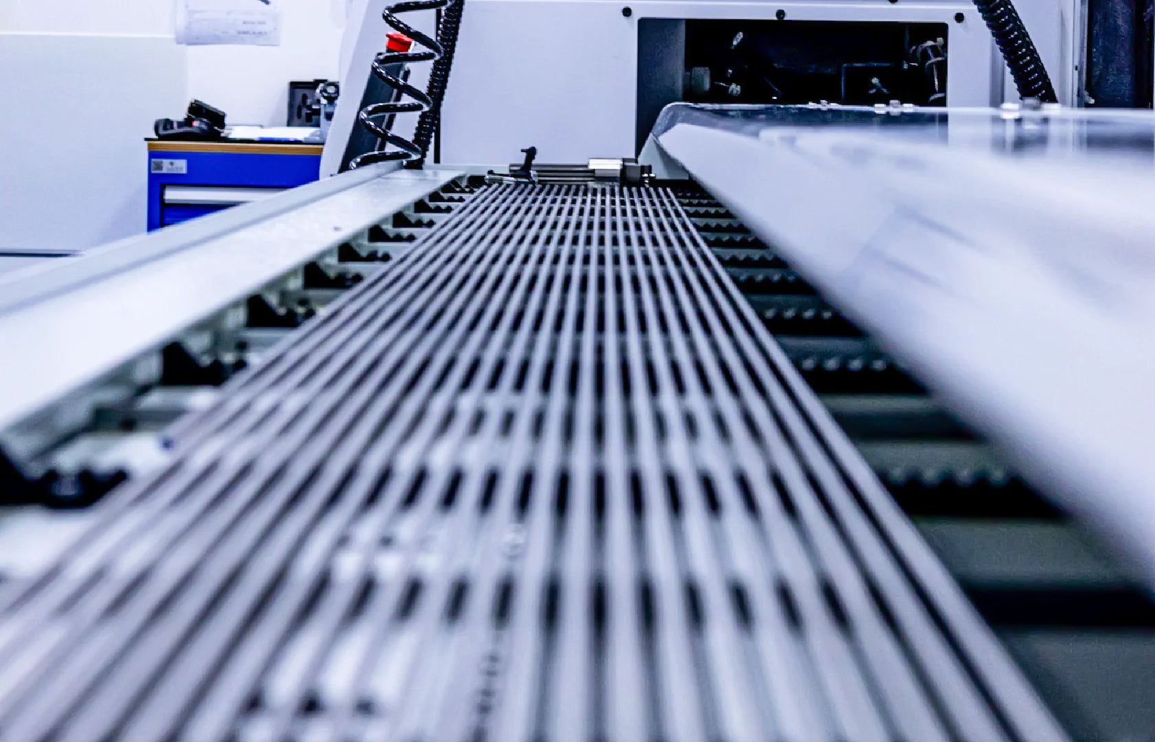 Titanium Grade 5 rods positioned inside a CNC production machine for dental implant manufacturing.