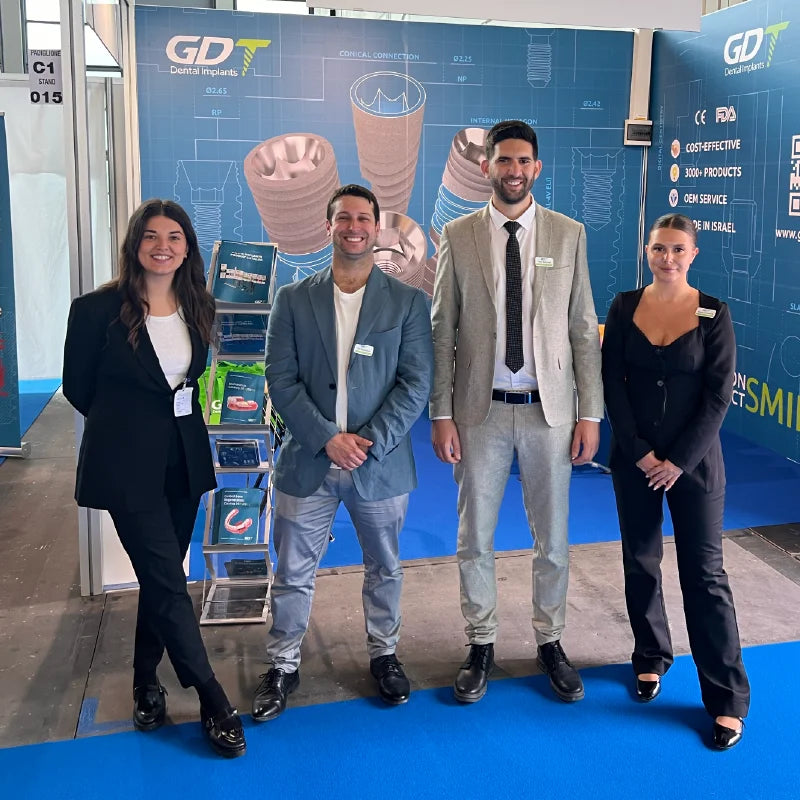 GDT Dental Implants team standing at the Expodental 2024 booth in Rimini, Italy.
