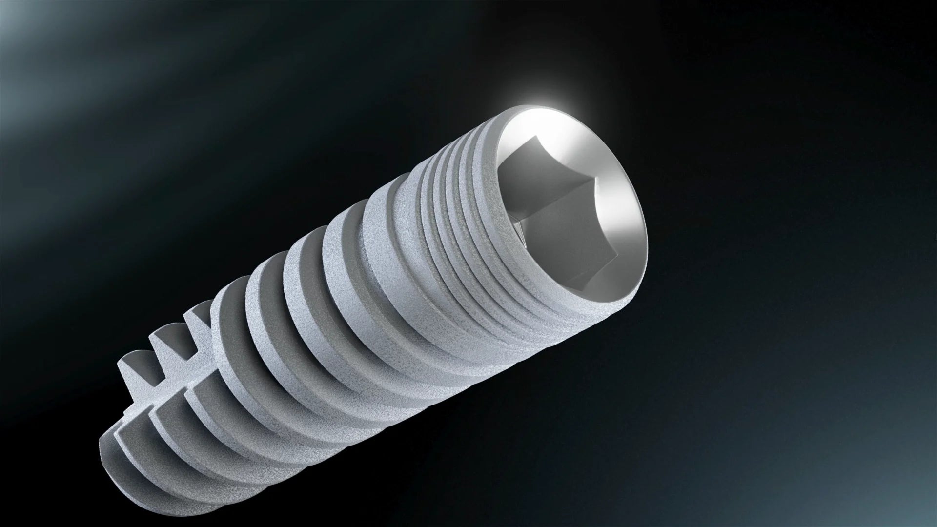 Cargar vídeo: 3D animation of a GDT dental implant showing the threaded implant body, internal connection, cutting geometry, and prosthetic component assembly.