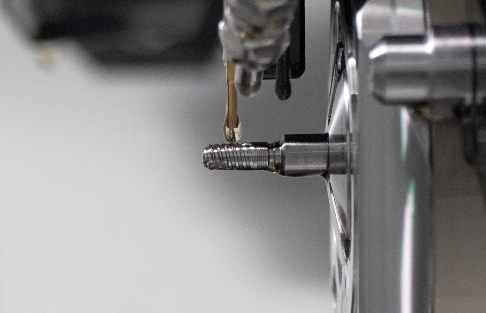 Close-up of a GDT dental implant during precision CNC machining.